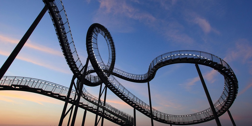 A dramatic black-and-white photograph of a roller coaster, one of the theme parks in Mahabaleshwar.