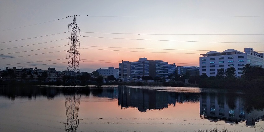 Kundalahalli lake with perfect reflections of the electricity tower and buildings.