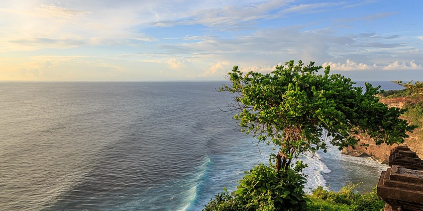 Kuta Beach with surfers riding the waves, a top destination for places to visit in June in Asia