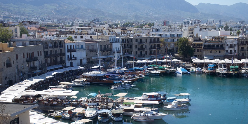 View of Kyrenia Harbor from Kyrenia Castle, Northern Cyprus, with boats under a clear sky.