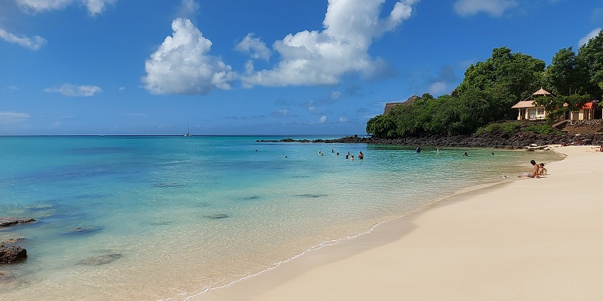 La Cuvette Beach in Grand Baie, showcasing clear turquoise waters and golden sand.