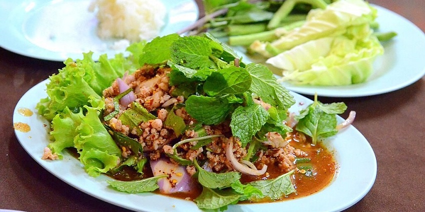 A spicy Thai minced meat salad from Chiang Mai, bursting with herbs, roasted spices, and smoky flavor
