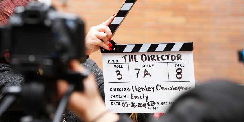 A person holding a clapperboard, one of the important short film festivals in India.