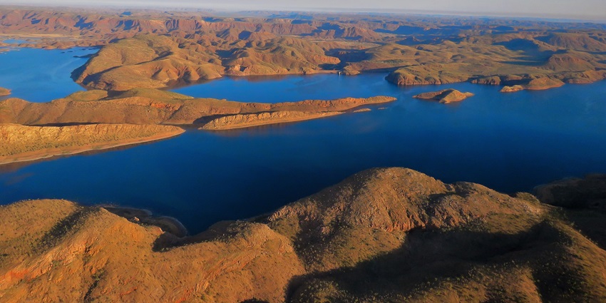 Panoramic view of the vast, serene Lake Argyle, surrounded by majestic mountains