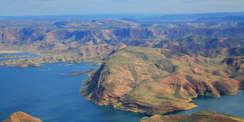 An image of Lake Argyle, with vast blue waters surrounded by rugged landscapes.
