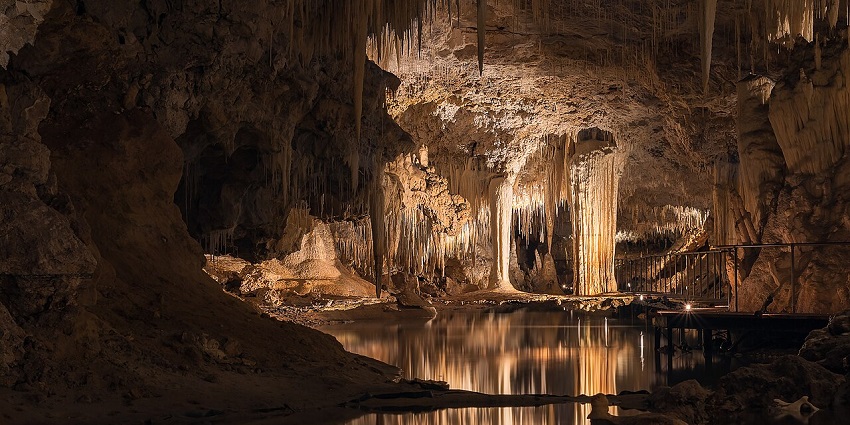 Lake Cave features a unique underground lake reflecting spectacular limestone formations