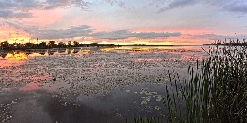 Lake Scugog’s peaceful waters reflect the sky, surrounded by small towns and nature trails.