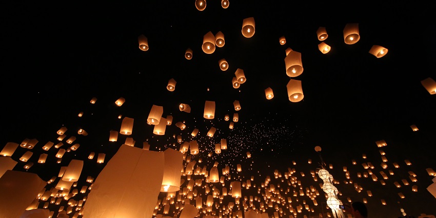 A stunning view of the sky with many lanterns during the lantern festival in Thailand.
