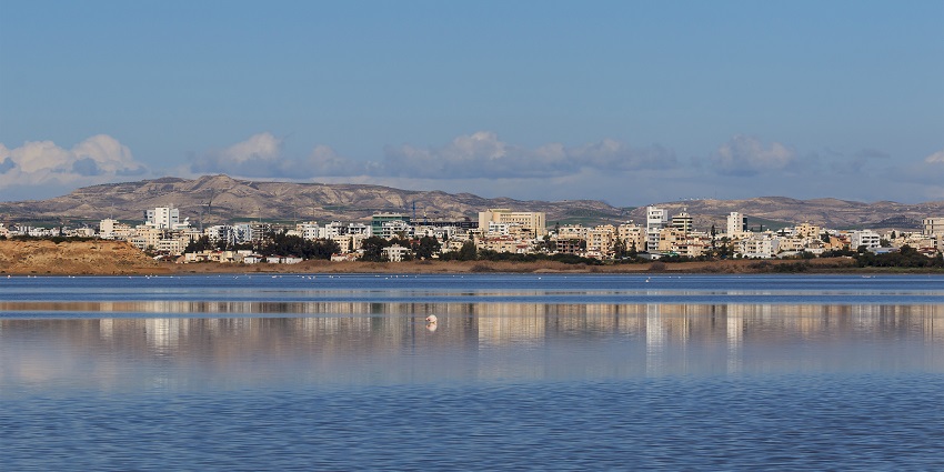 Larnaca Salt Lake with calm waters reflecting the sky, located in Larnaca, Cyprus.