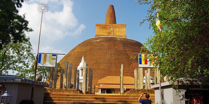 A man capturing an image of Abhayagiri Vihara, among top things to do in Anuradhapura.