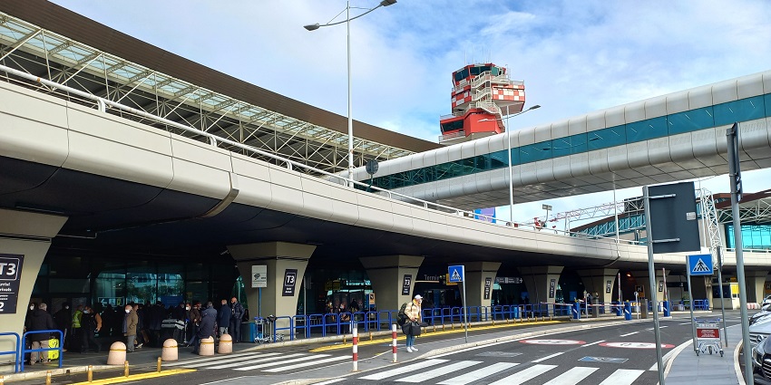 A passenger crossing walkway after exiting Leonardo da Vinci Rome Fiumicino Airport.