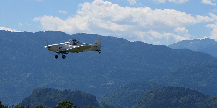 An aircraft in the blue sky paving its way out through the floating clouds all decked in white