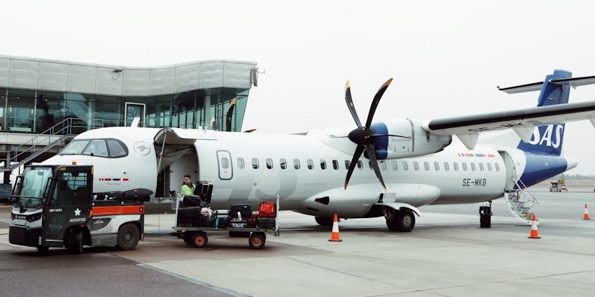 An aircraft being loaded with luggage at the airport during ground operations.