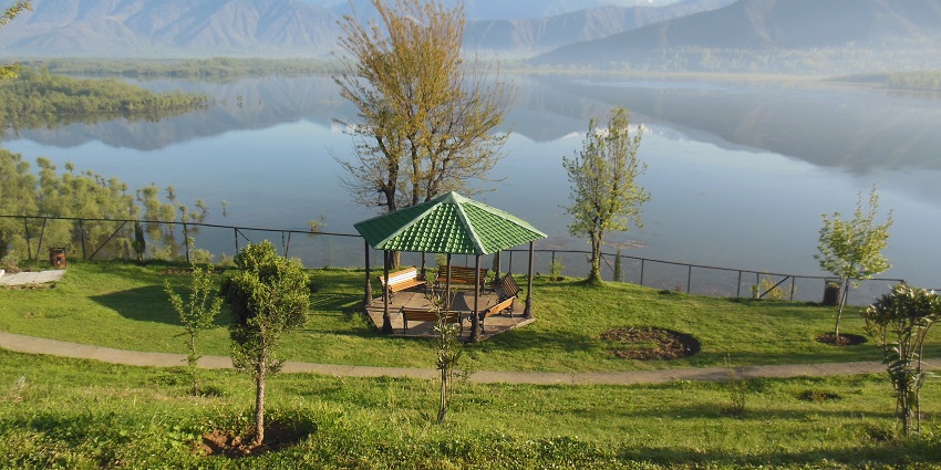 Wular lake from top with iron fences, green shorelines, mountains and a hut-like structure
Viewers of this file can see comments and suggestions