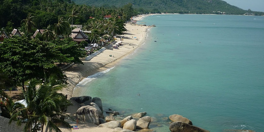 Stunning aerial shot of Lamai Beach, featuring crystal-clear waters and lush palm trees.