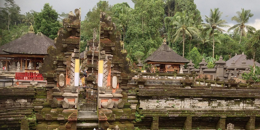 Tirta Empul Temple in Bali, surrounded by lush forests, is a sacred water temple.
