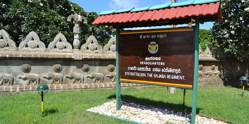 Signage board of Fort Frederick, with natural surroundings around.