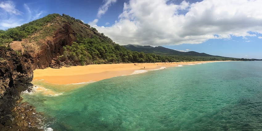An image of the expansive Makena Big Beach in Maui, Hawaii, with golden sand and waves.