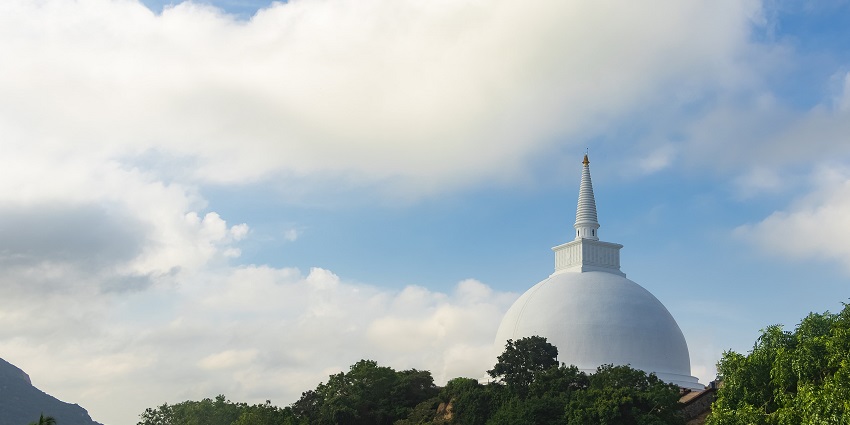 White stupa at Mihintale under a bright blue sky, a highlight in Mihintale travel guide