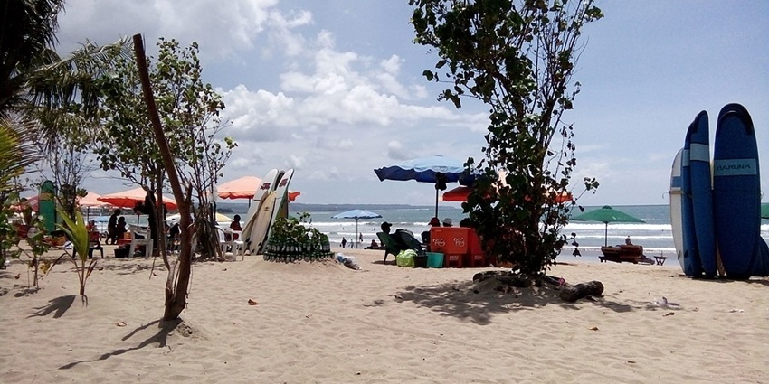 Kuta Beach has golden sands and is a lively hub for surfers and travellers alike.