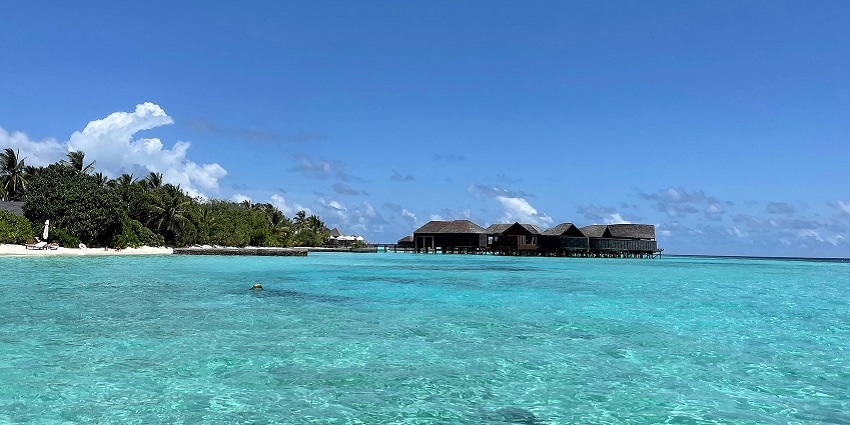 Veligandu Island with clear waters, coral reefs, and stunning views.