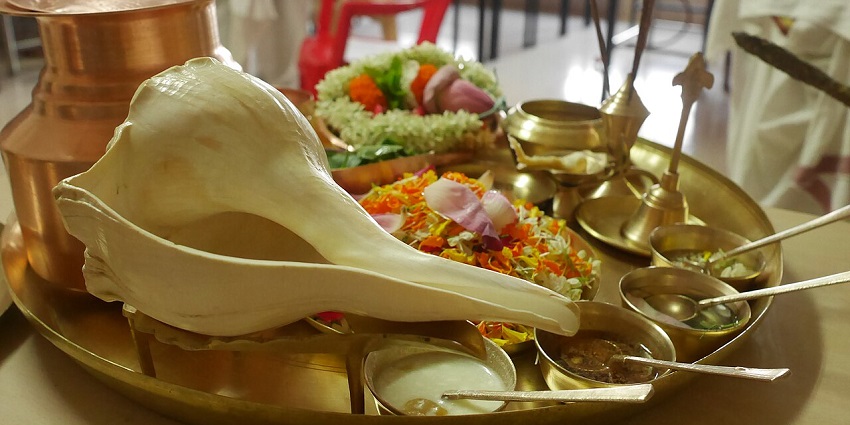 A pooja thali decorated with pancamrta, flowers and conchshell at Shantadurga Kunkalikarin Temple.