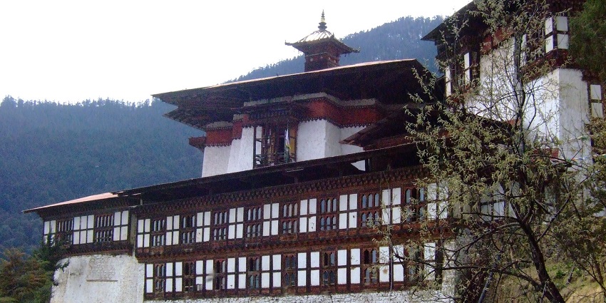 An image showing the historic Cheri Monastery, surrounded by dense greenery in Thimphu.