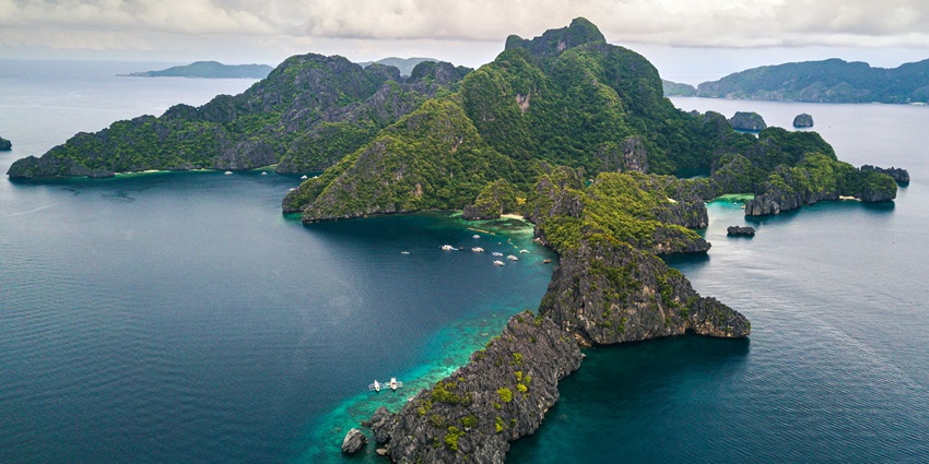 Image showing Trobriand islands landscape with dense vegetation, bordered by the sea.