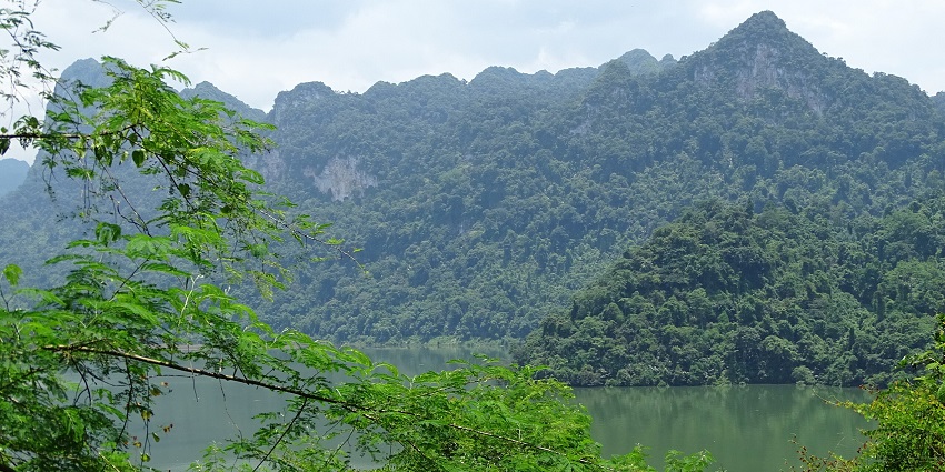 A picturesque view of Ba Be Lake, with mountains reflecting in the still waters