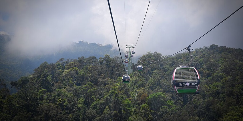 A panoramic view of Ba Na Hills, showing the cable car ride and lush greenery.