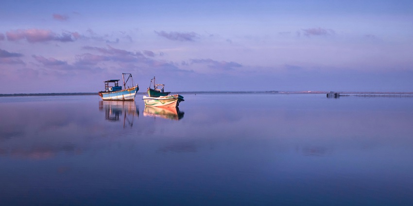 Jaffna's location in northern Sri Lanka surrounded by azure waters and boats.