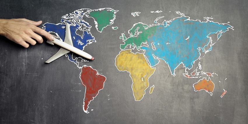 A view of a colourful map drawn on a blackboard with a small aeroplane kept on it.