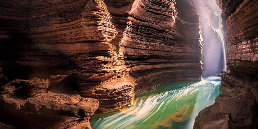 An underground river flows through the mystical Gupteshwor Cave, creating a stunning view