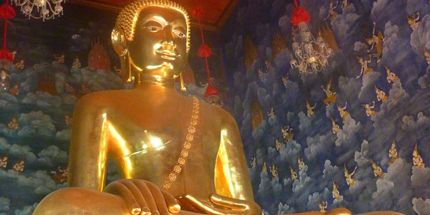 A picture of Bangkok Gold Buddha inside Wat Traimit, gleaming under temple lights.