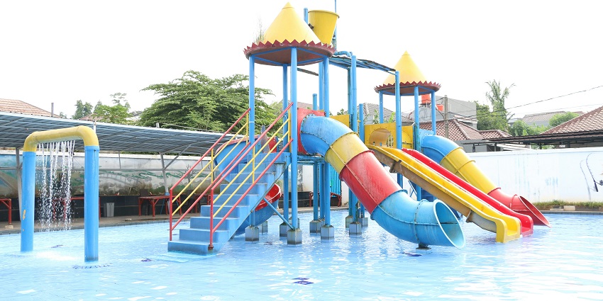 A view of children sliding down the white slides at a famous water park near Kurukshetra.