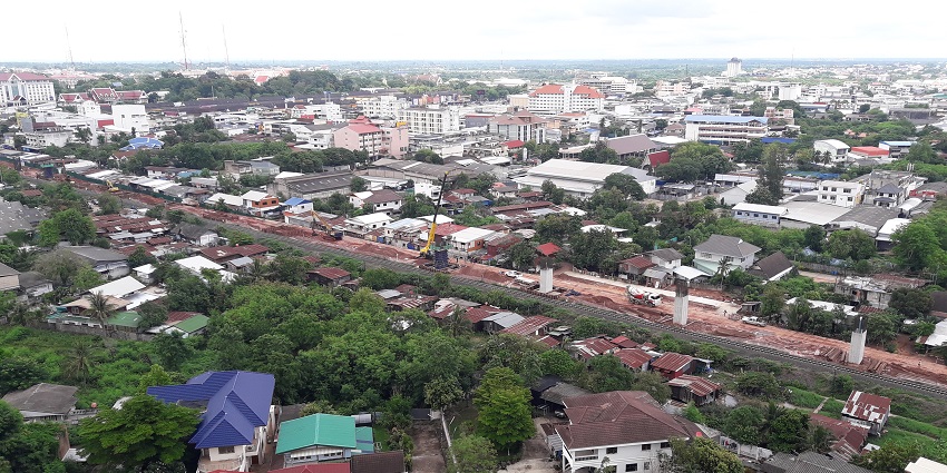 Thailand featuring ancient ruins and modern cityscape blending together.