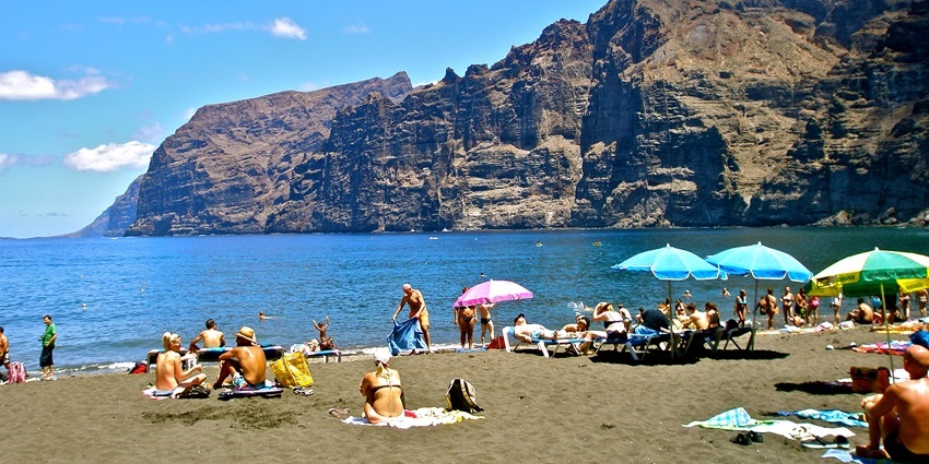 Vibrant atmosphere at the Los Gigantes Beach, one of the black sand beaches in the world.