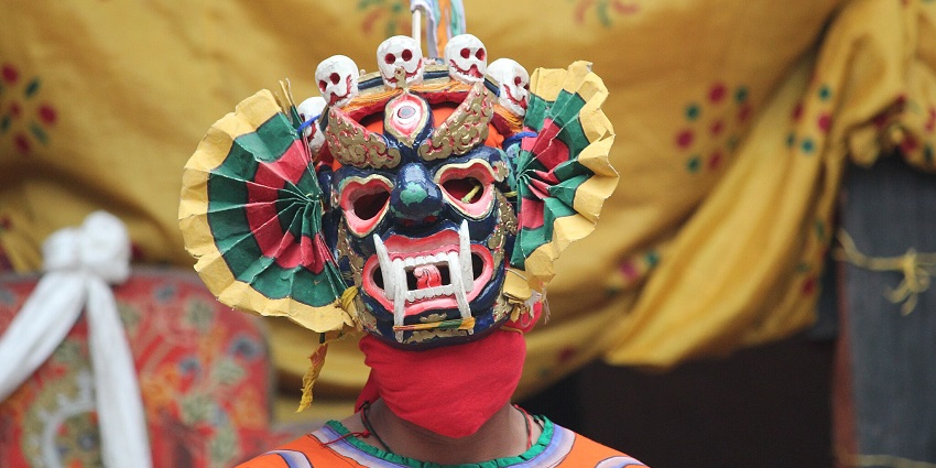 An image showing a Ging cham dance character performing during the Losoong celebration.