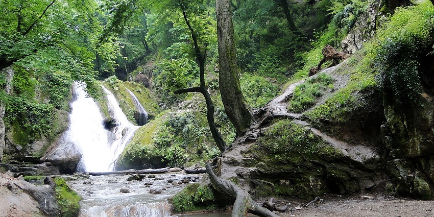 Photograph of Love Waterfall, where crystal clear water tumbles over rocky terrain