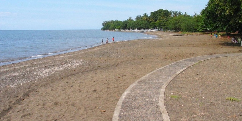 Coastal view at Lovina Beach, near Sekumpul waterfall where greenery meets the calm sea