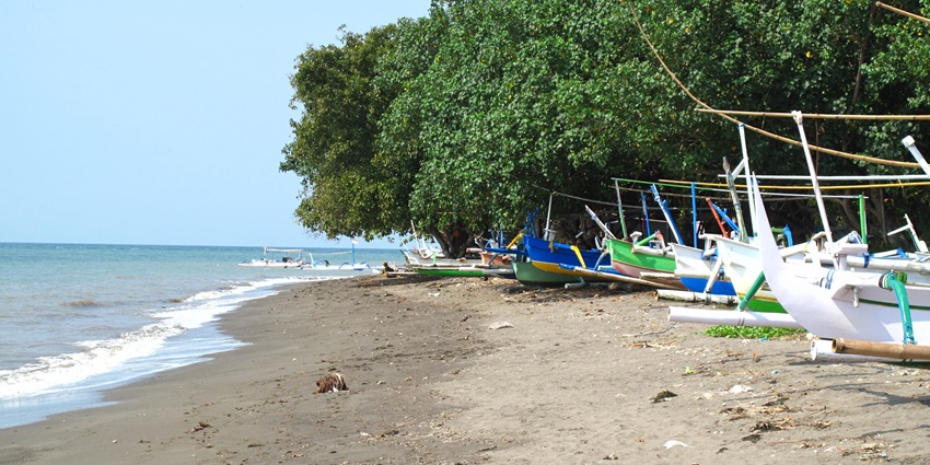 A peaceful morning at Lovina Beach, Bali, with crystal-clear waters and soft golden sand