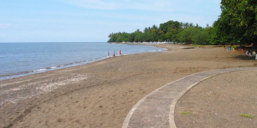 Tranquil Lovina Beach in Bali, offering calm waters and stunning views near Banjar Hot Springs Bali.
