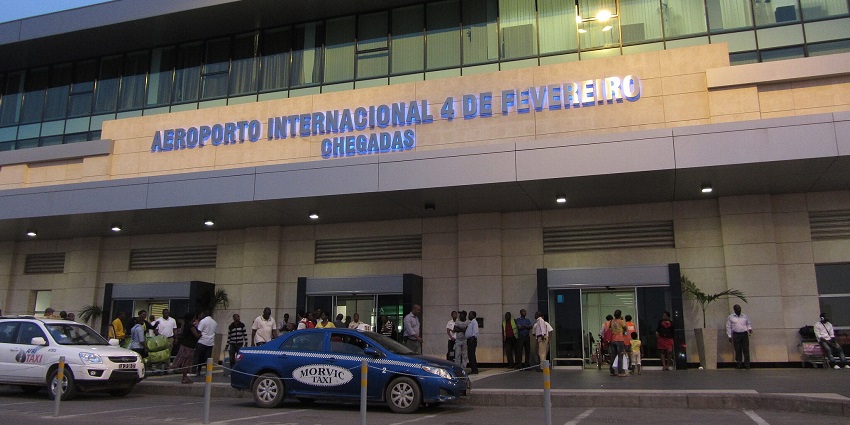 Luanda Quatro De Fevereiro airport from far away with aeroplanes parked and buildings.