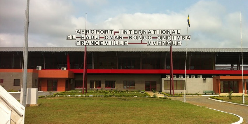 Terminal building of M'Vengue El Hadj Omar Bongo Ondimba International Airport and flags