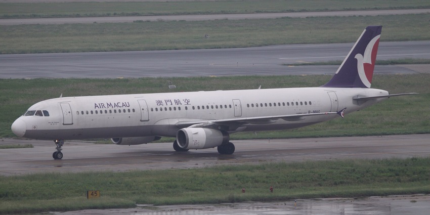 MAG Airbus A321 commercial aircraft parked on the runway with purple and red design