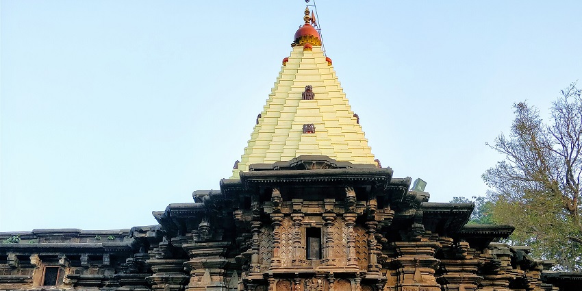 A detailed, ornate stone facade of Mahalaxmi Temple, one of the key Kolhapur Temples
