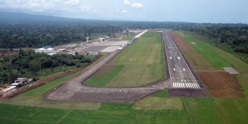 An aerial view of Malabo Airport shows its runway, taxiways, and the surrounding terrain