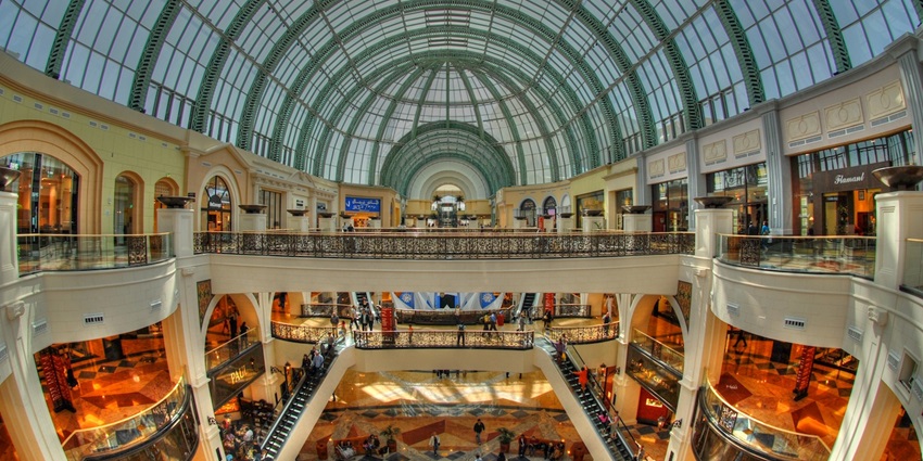 A picture of the interior of a huge shopping mall in Dubai with numerous brand stores all around