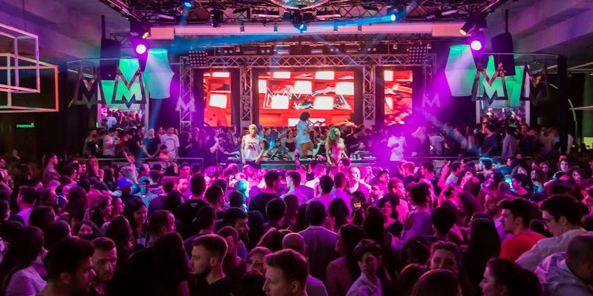 People in enjoying the music and dancing in the club
