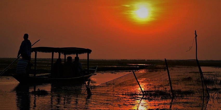 A scenic sunset view reflecting on the waters of Mangalajodi.